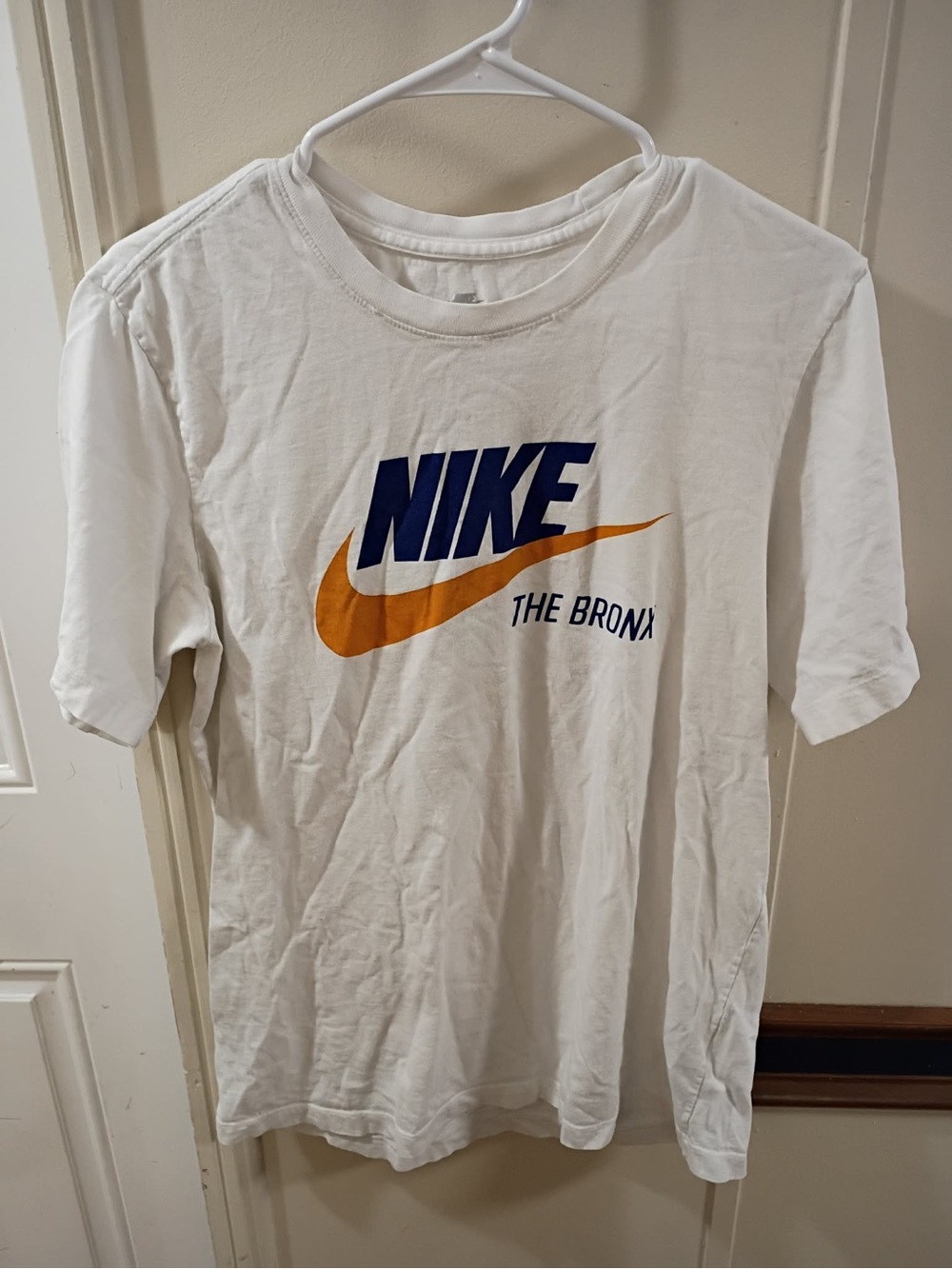 Nike White Short-Sleeve Tee with Navy Logo and Gold Swoosh